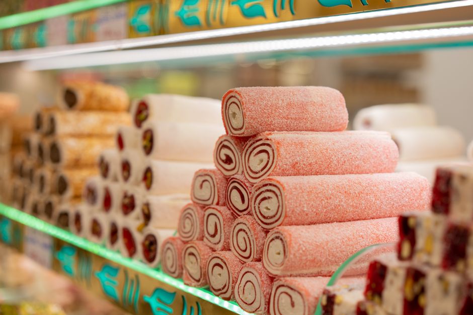 Vibrant display of assorted Turkish delight rolls in a traditional Istanbul shop.
